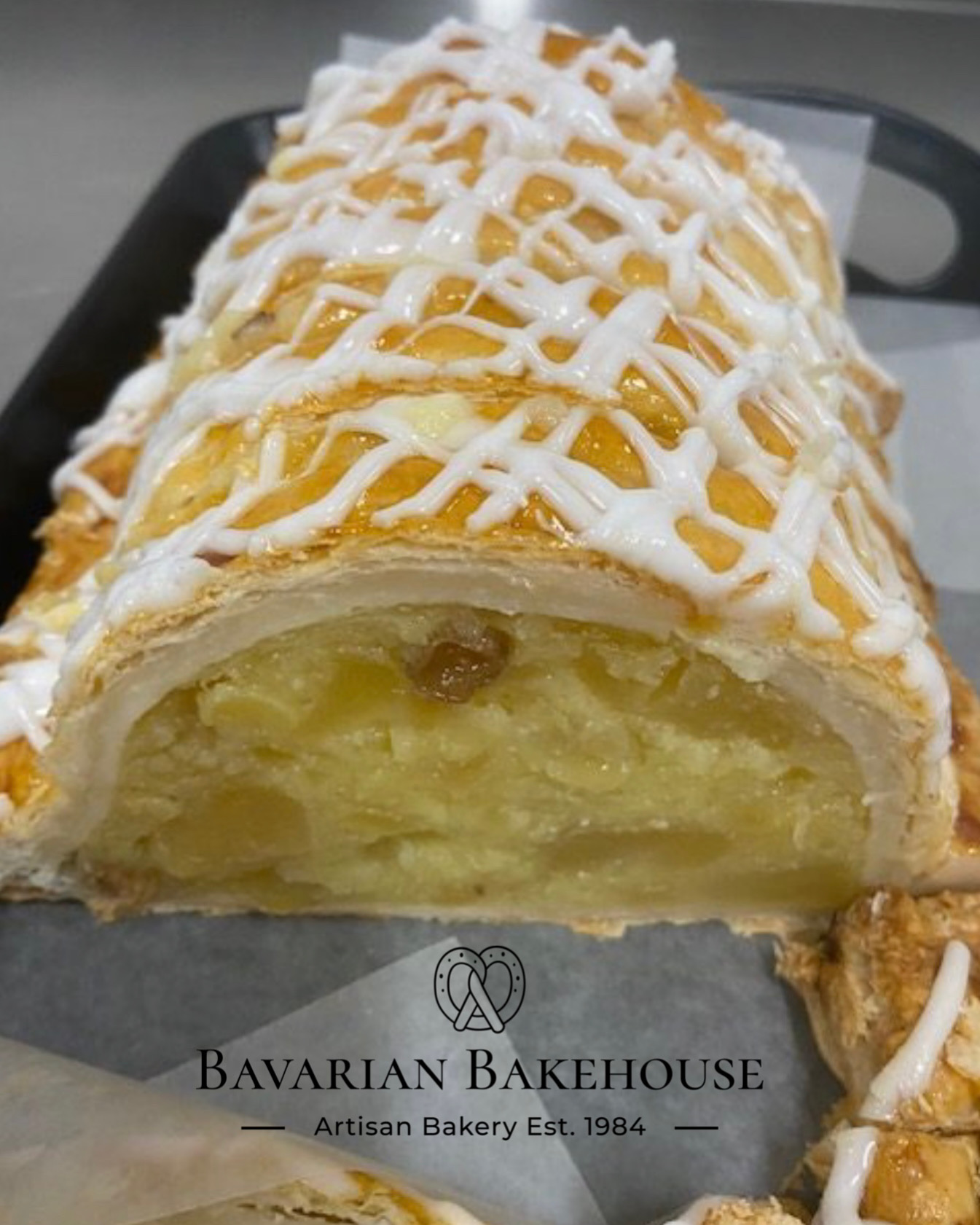 layers of puff pastry around a rich custard and fruit strudel filling