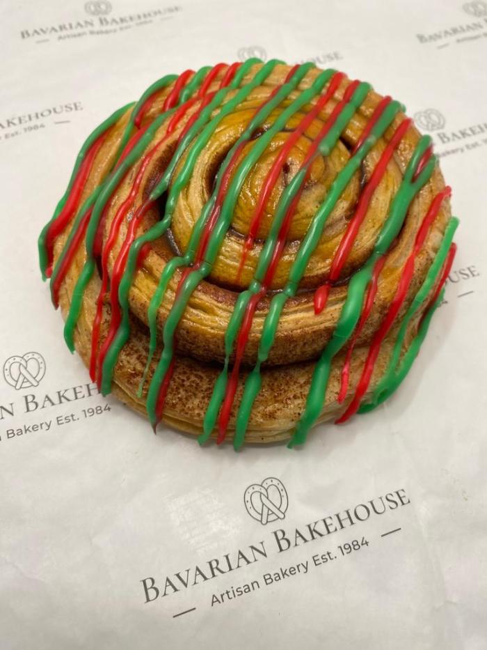 crisp cinnamon swirl made of puff pastry drizzled with red and green festive icing