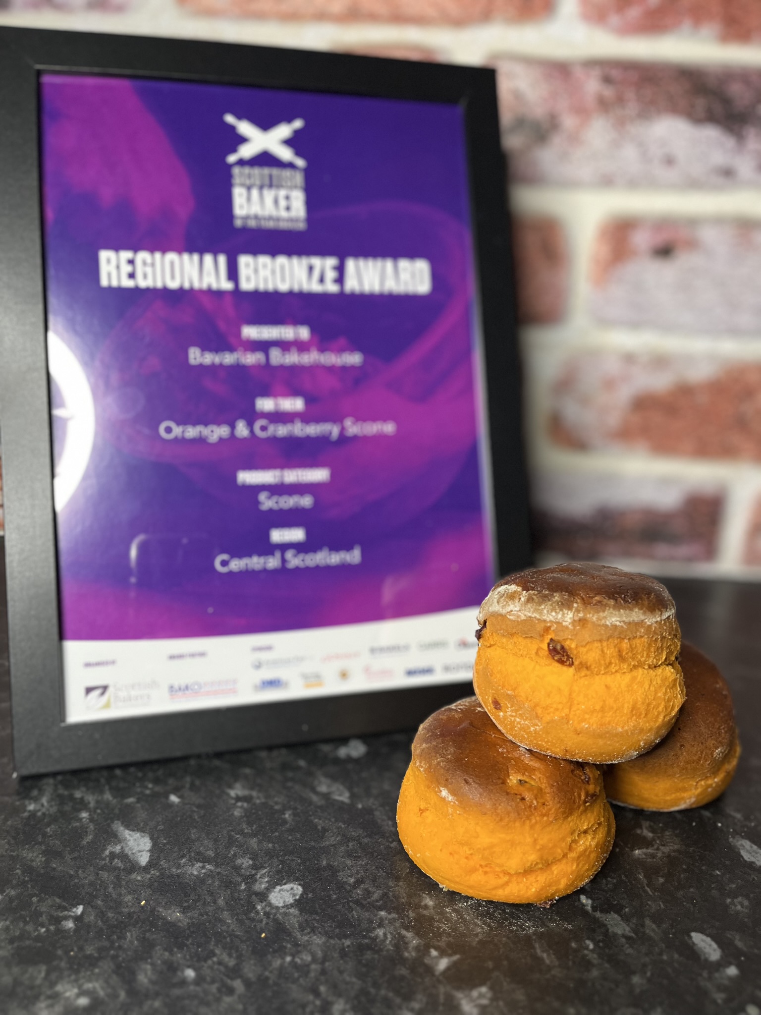 Soft zingy orange and cranberry scones. In front of the reginal bronze award