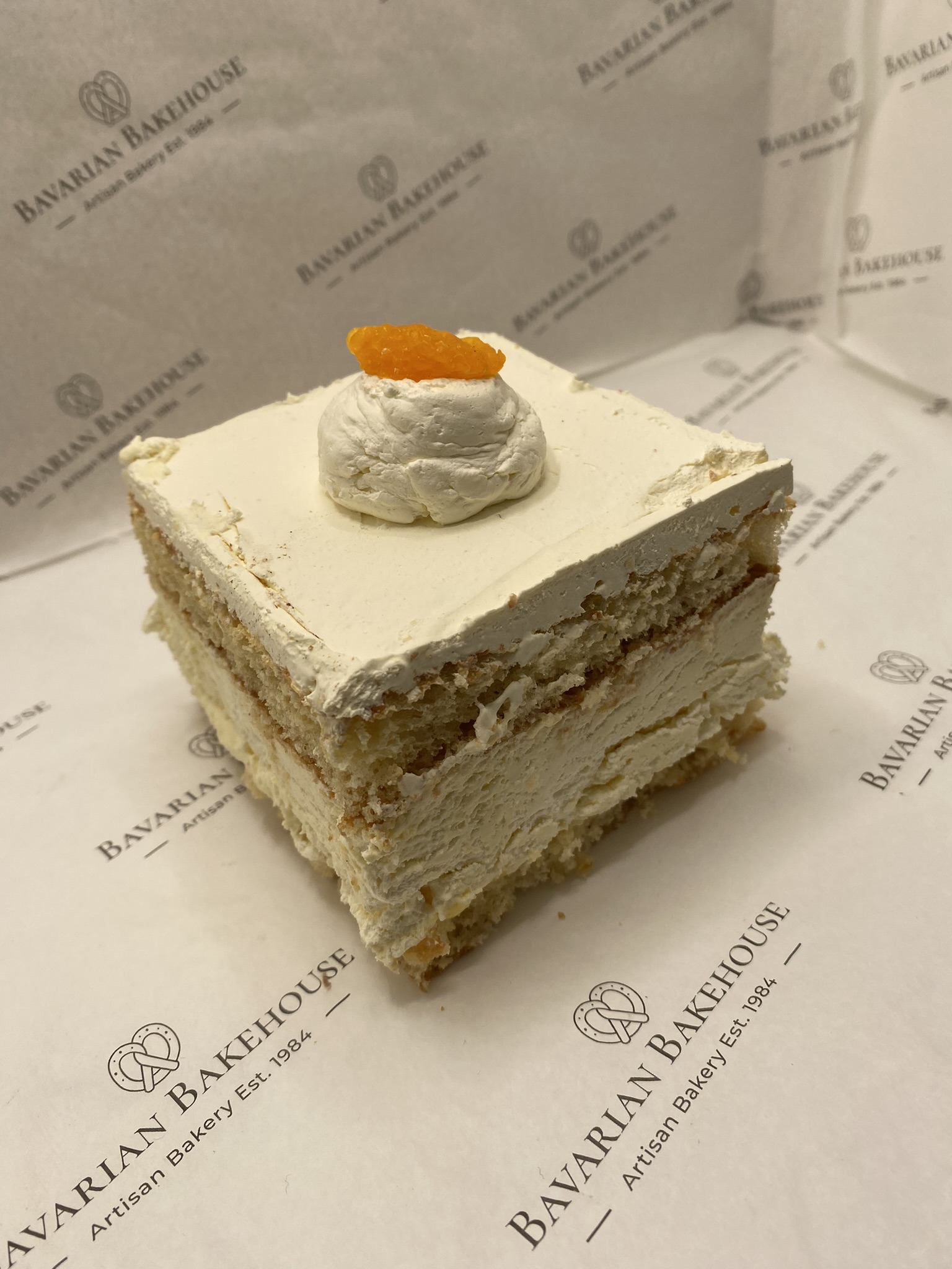 vanilla sponge layered with cream, fruit filling, topped with cream and a mandarin segment