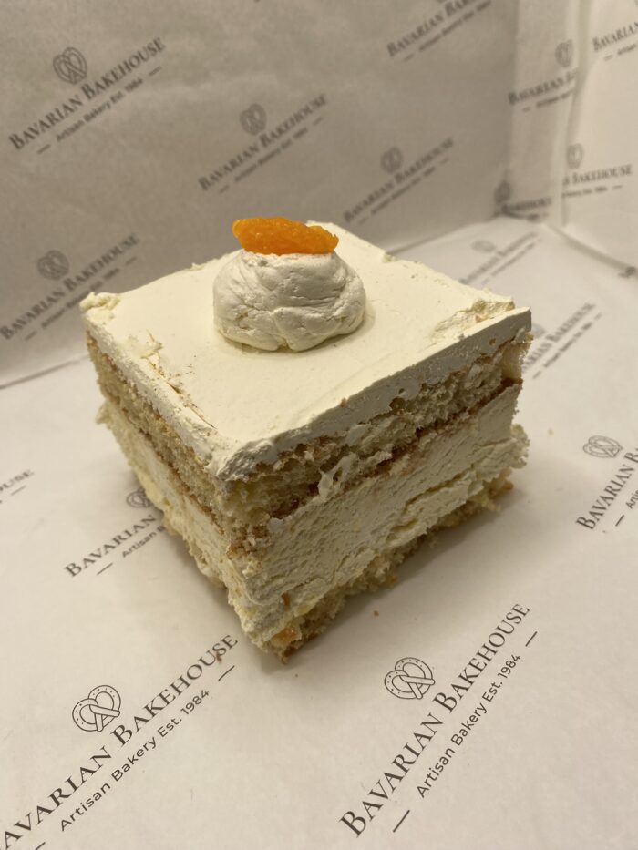 vanilla sponge layered with cream, fruit filling, topped with cream and a mandarin segment