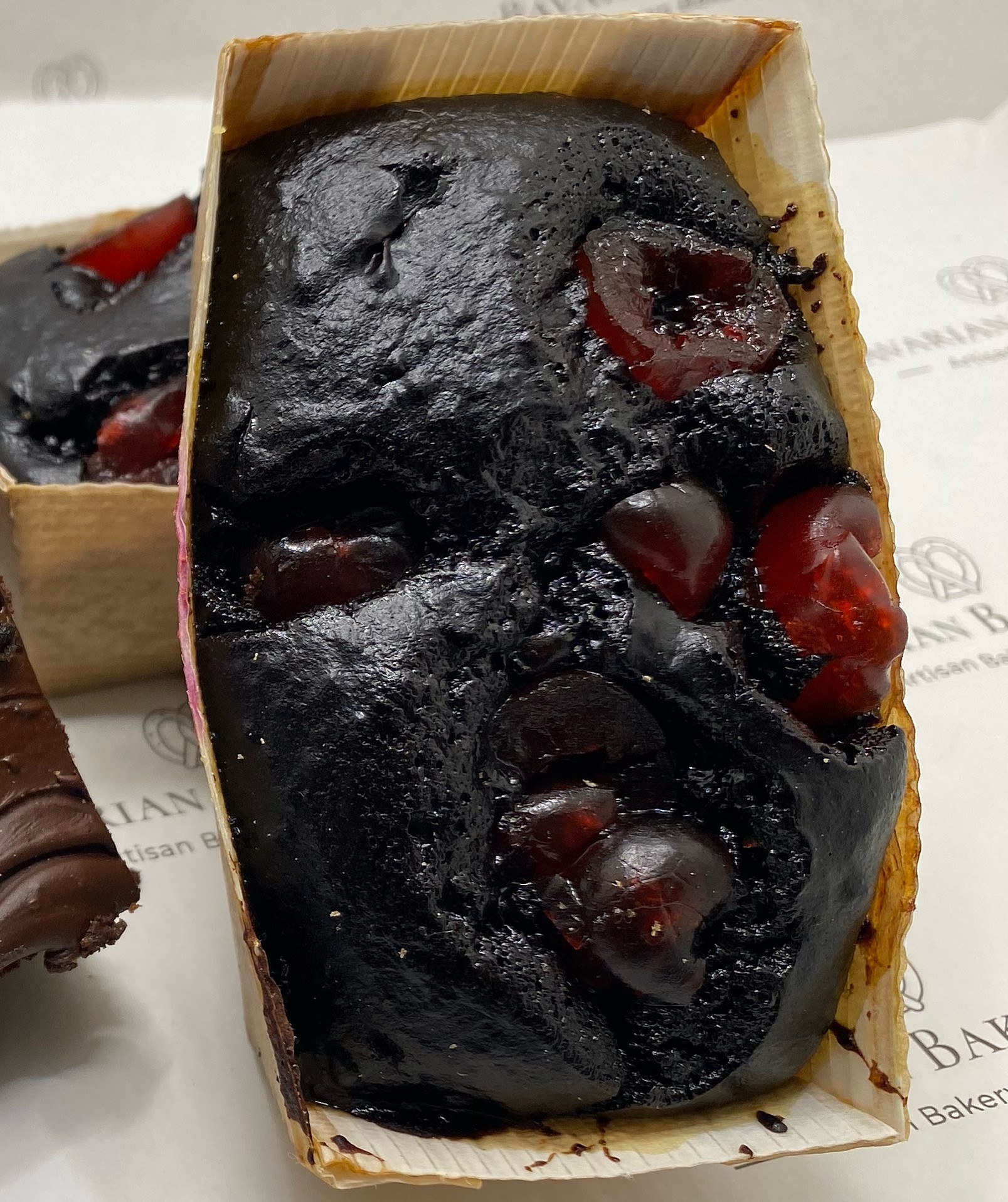 Moist and rich flavoured vegan cherry brownie in a mini loaf case for individual portions