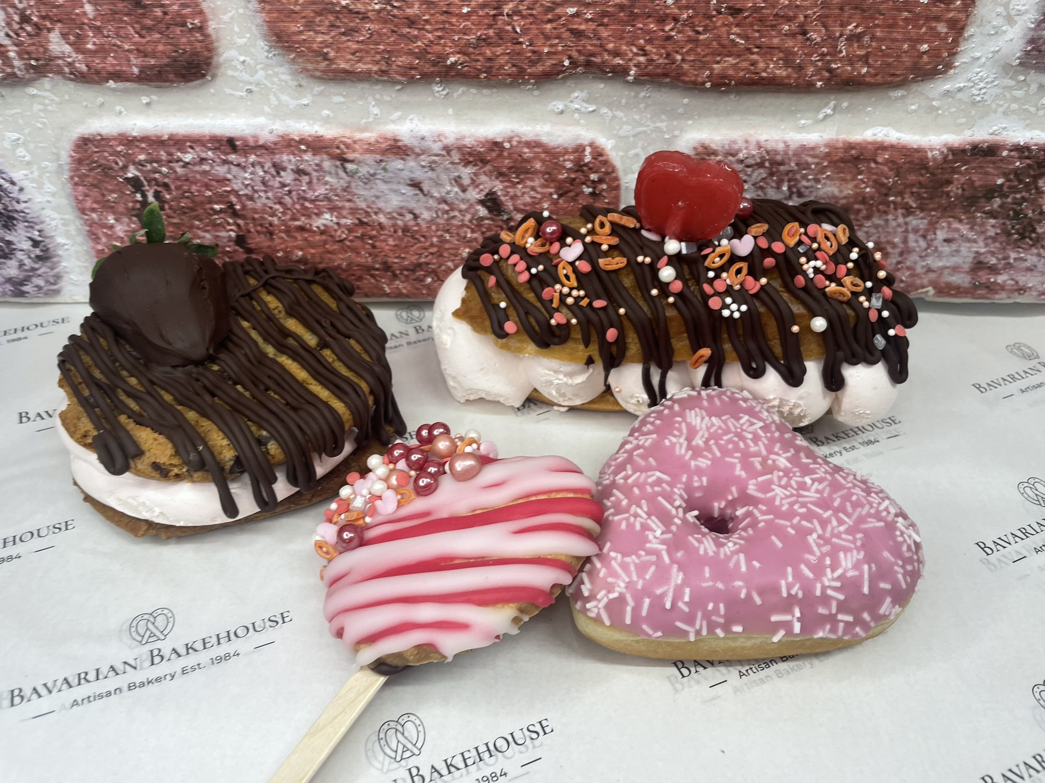 valentine box- chocolate strawberry cookie sandwich, heart lolly biscuit, 1 heart doughnut, 1 half sized strawberry cream chocolate drizzle éclair