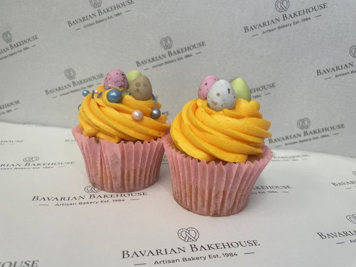 Vanilla sponge cupcakes topped with a swirl of yellow icing and topped with an assortment of edible Easter toppers, sprinkles or mini chocolate eggs.