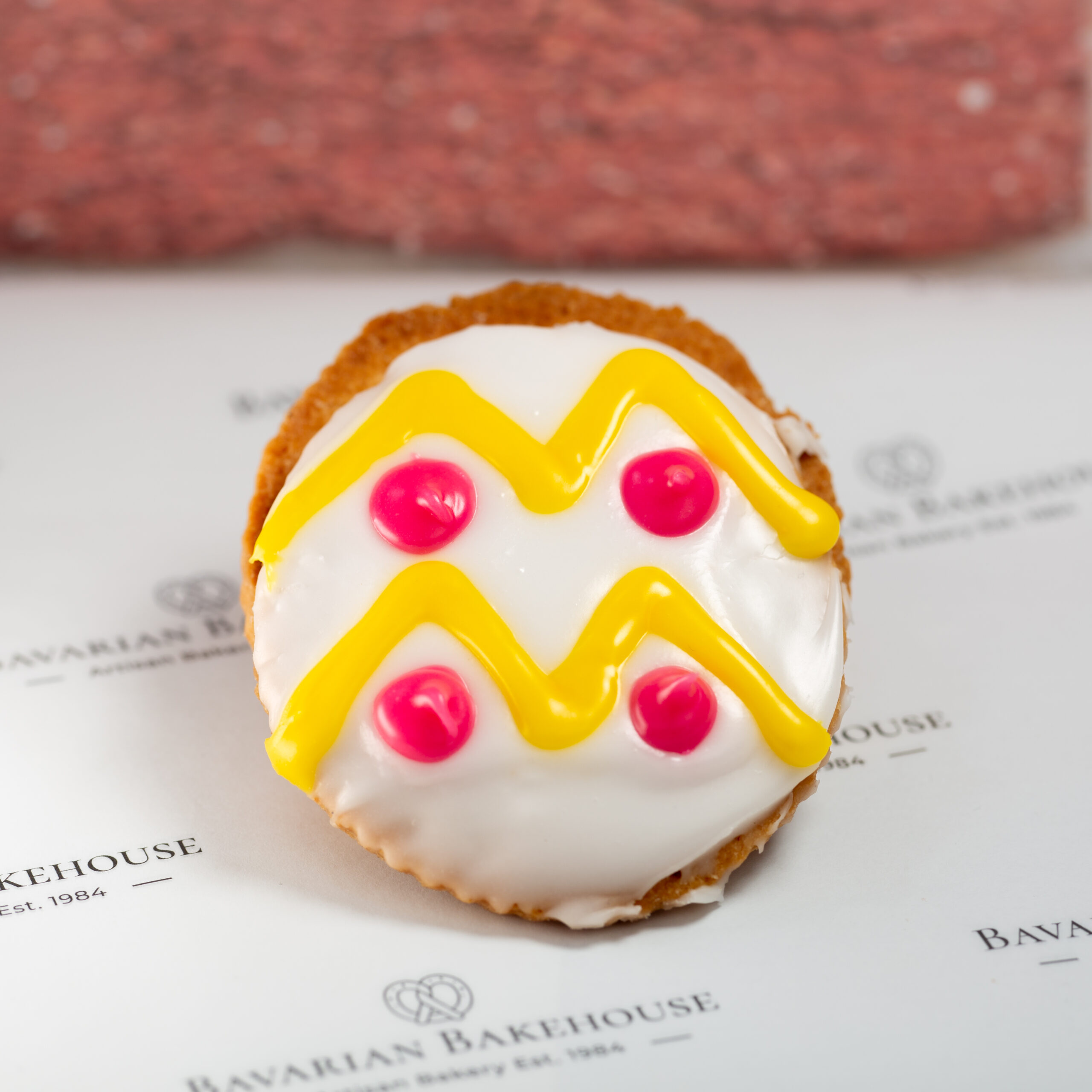 hand cut empires filled with lemon curd decorated with white fondant and colourful fondant flood designs to look like easter eggs.