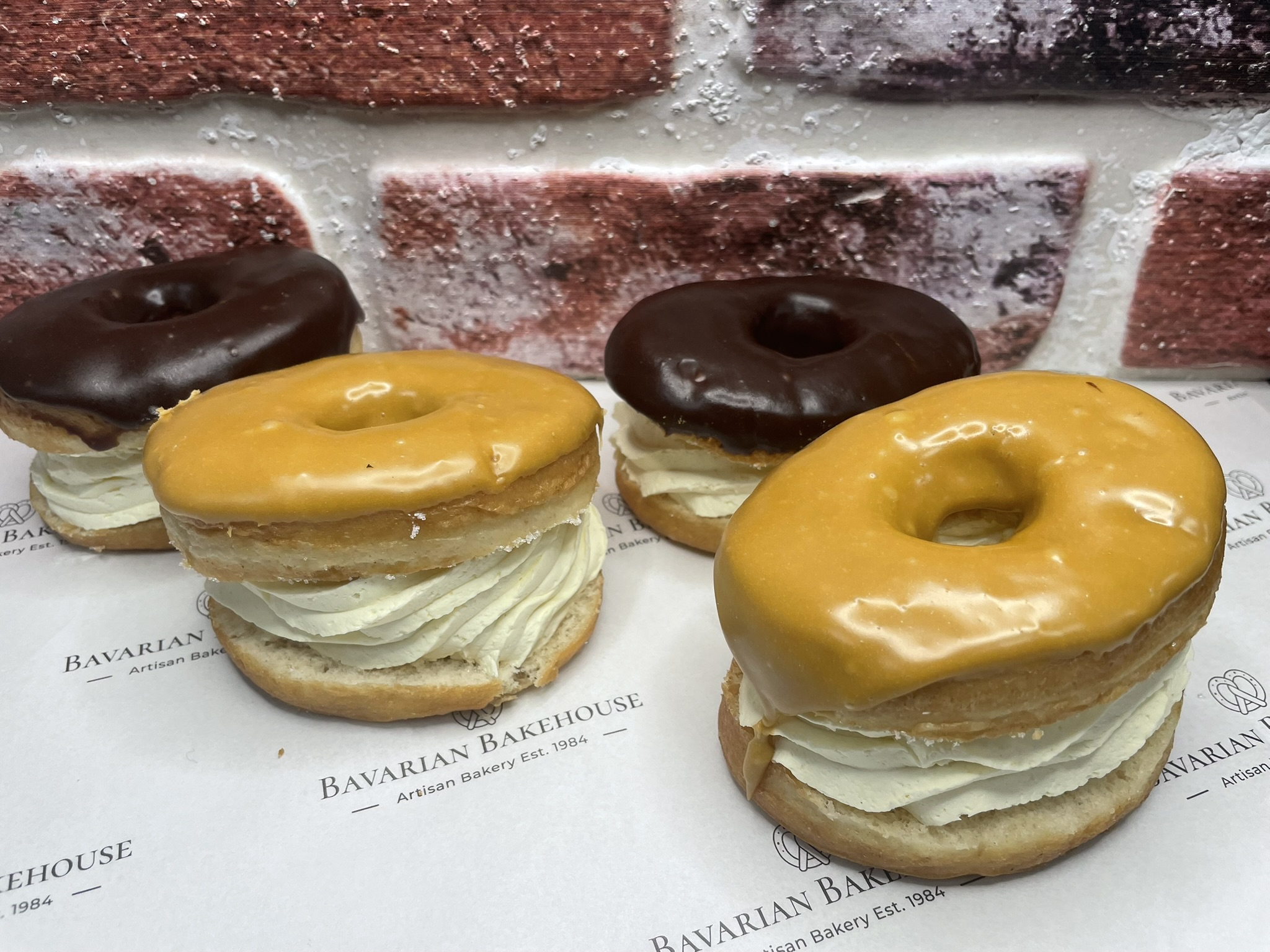 soft doughnut rings, sandwiched with cream topped with chocolate fudge icing