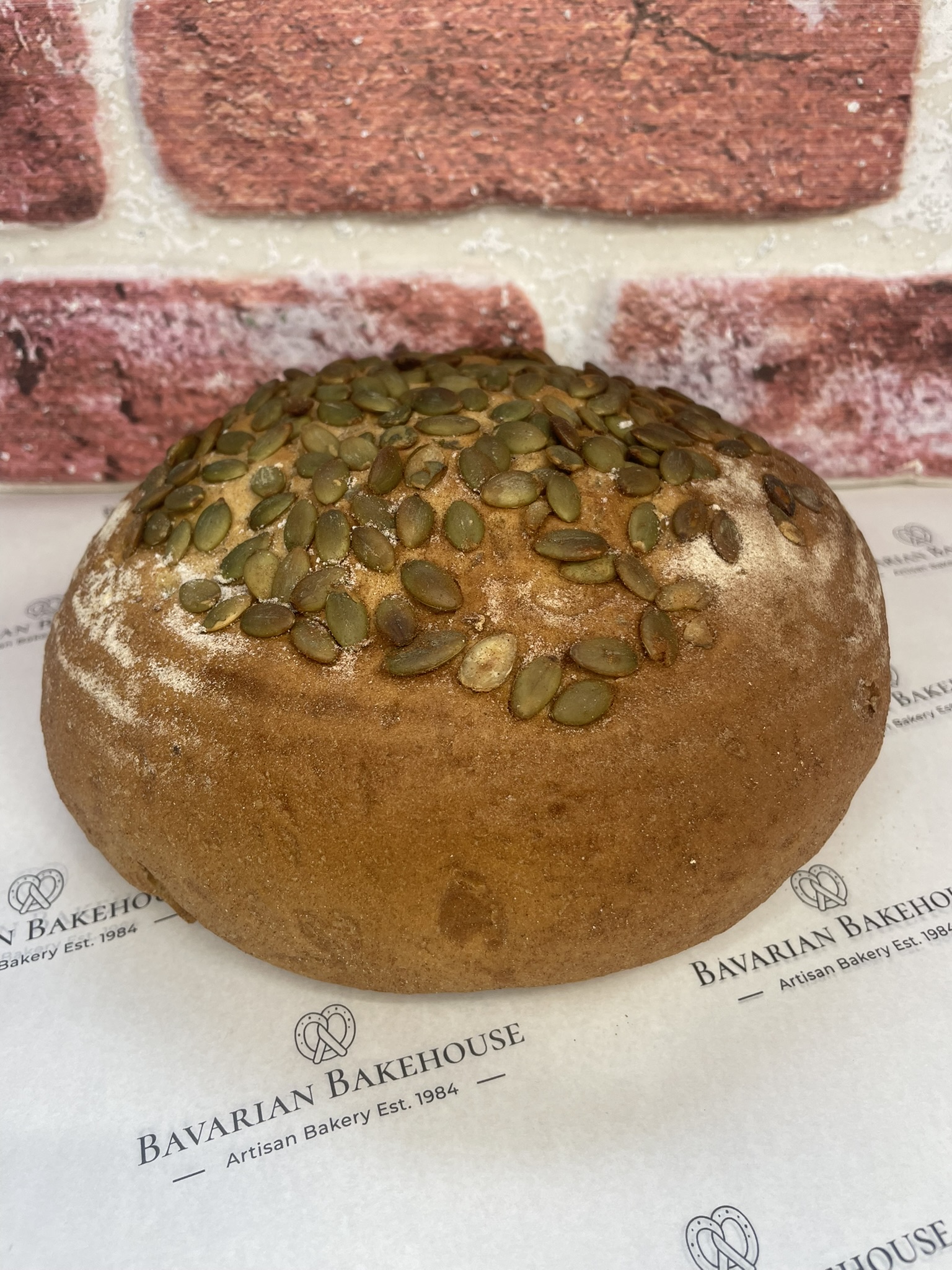 round and handmade rye cobb topped with green pumpkin seeds.
