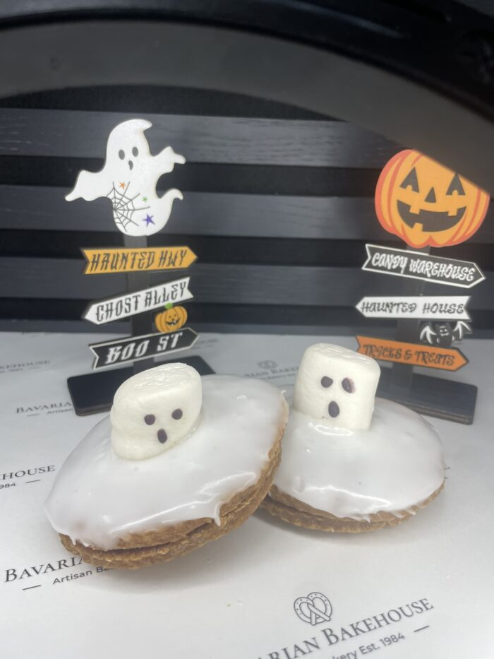 Inhouse vegan biscuits with a layer of apple/raspberry jam, topped with white fondant, and a vegan white marshmallow decorated with black eyes and mouth