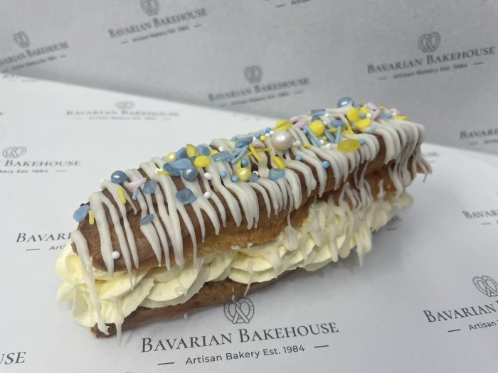 choux eclair filled with lemon cream, topped with a fondant drizzle and assorted Easter sprinkles and decorations
